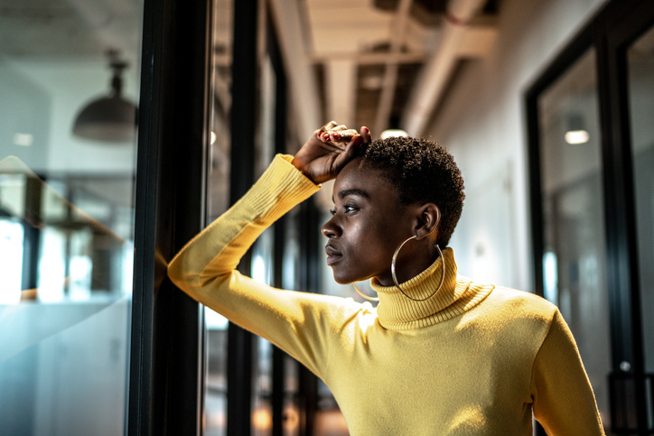 Worried young businesswoman at corridor office